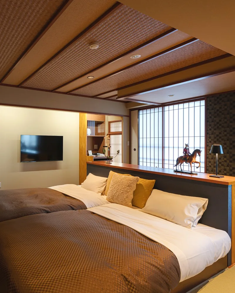 Twin beds and a smart television in the renovated room