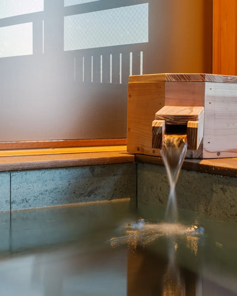Hot water running into the stone bath